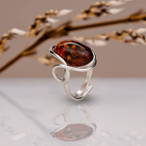 BalticBliss genuine amber adjustable ring with elongated cognac Baltic amber cabochon in elegant sterling silver swirl setting, authentic Lithuanian handmade Baltic amber jewelry, luxury real amber ring gift for women