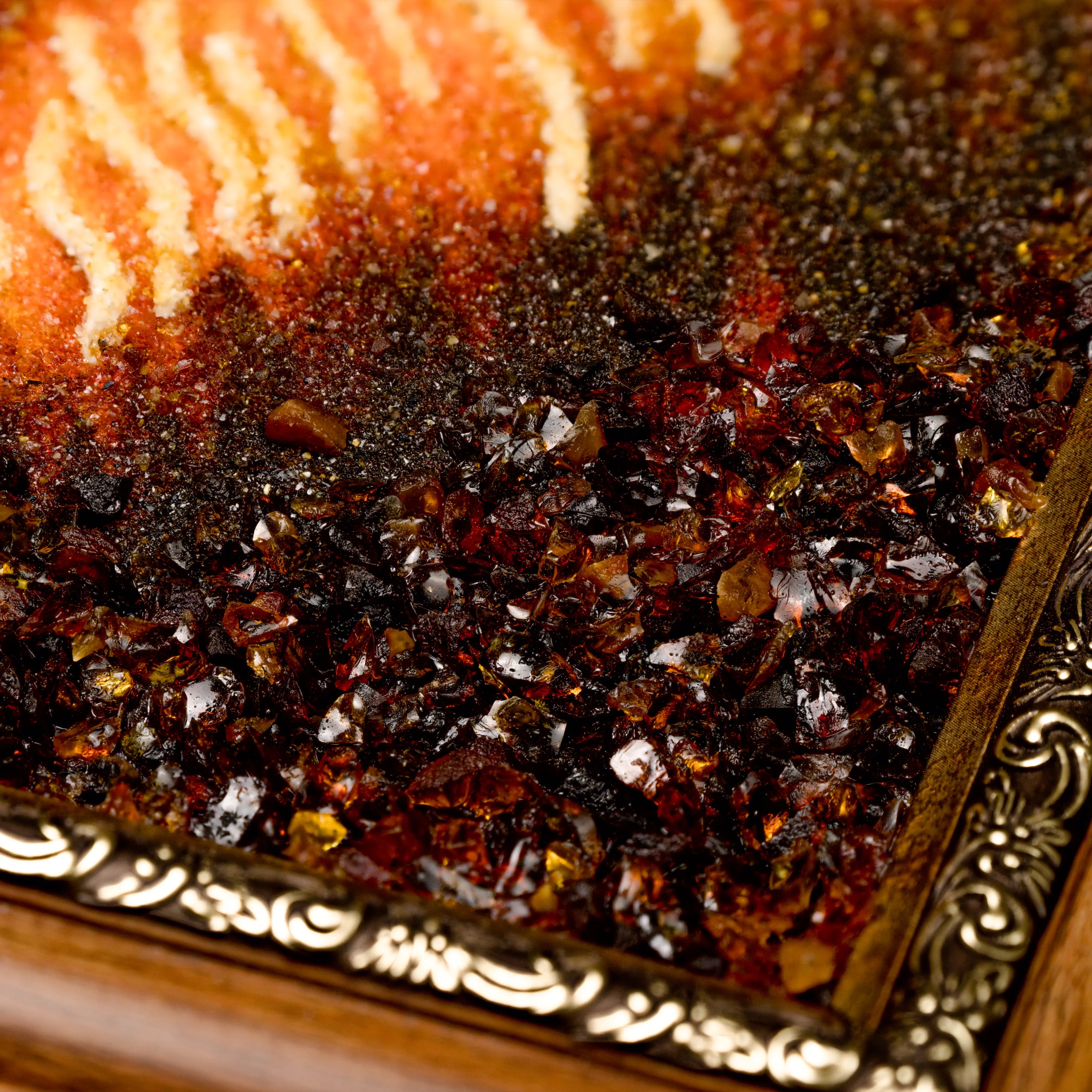 Detail of BalticBliss genuine amber wildlife painting showing rich dark cognac Baltic amber chips and gradient fur texture, ornate gilded frame corner, authentic Lithuanian handmade amber art for luxury home décor.