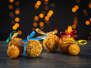 BalticBliss genuine Baltic amber Christmas ornament ball set, sparkling natural amber chips in assorted sizes with green, blue, gold, red and yellow ribbon bows, handmade in Lithuania eco‑friendly holiday décor ships worldwide
