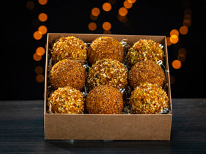 BalticBliss set of nine genuine Baltic amber Christmas ornament balls in eco‑friendly kraft gift box, handmade in Lithuania from sparkling natural amber chips for sustainable holiday décor, authentic Baltic amber ornaments ship worldwide