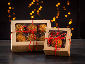 BalticBliss genuine Baltic amber Christmas ornament balls gift set in eco‑friendly kraft window boxes—six‑piece and single‑piece packaging options tied with red string—handmade in Lithuania, authentic Baltic amber holiday décor ships worldwide