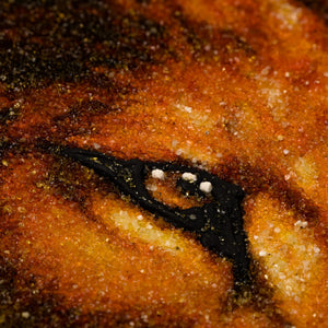 Macro close-up of BalticBliss genuine amber wildlife painting, detailed animal eye sculpted from natural Baltic amber grains and sand, authentic Lithuanian handmade amber art picture texture for luxury home décor.
